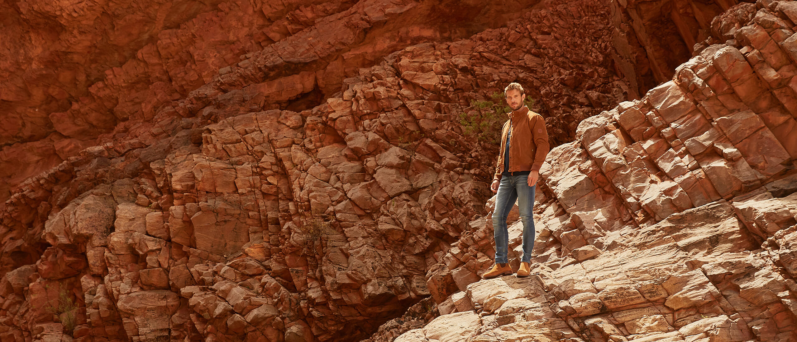 R.M.Williams suede jacket, denim jeans and Craftsman boots standing on rock at Simpson Gap R.M.Williams suede jacket, denim jeans and Craftsman boots standing on rock at Simpson Gap